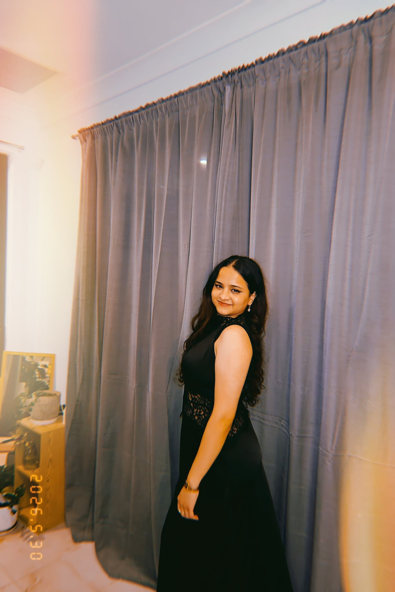 A woman with long dark hair in an elegant black dress